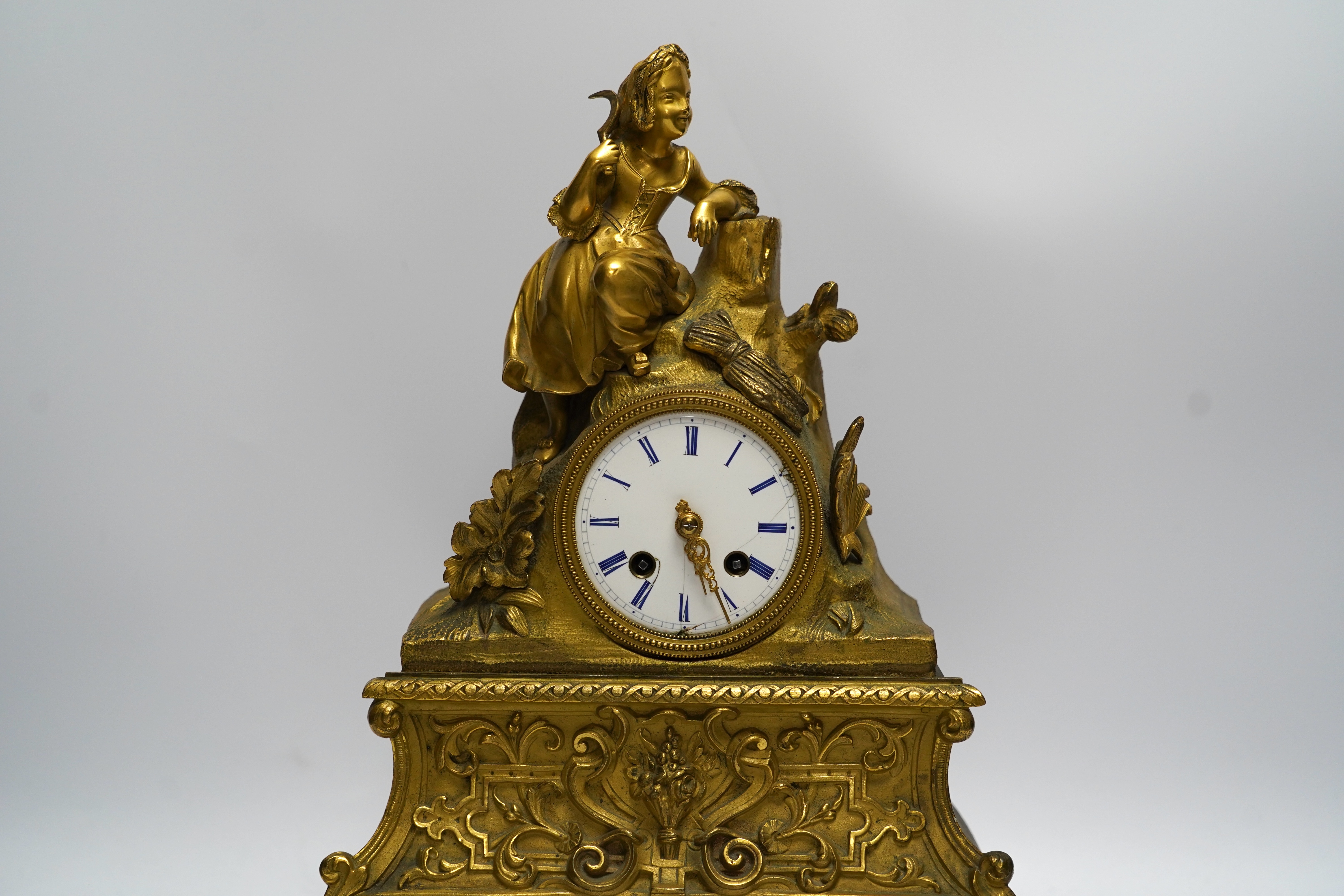 A mid 19th century French ormolu figural mounted clock with silk suspension, with key, 36cm